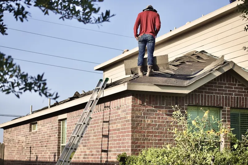 Professional roofer working on a residential roof in Anna Maria